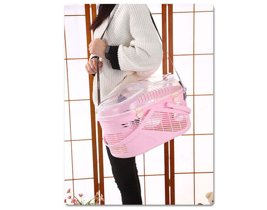 Lightweight YES4PETS pink pet carrier being held, ideal for small dogs, cats, rabbits, and guinea pigs.