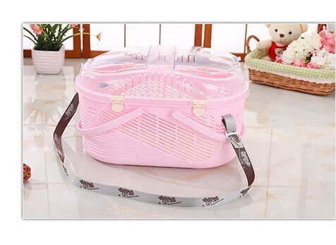 Lightweight pink pet carrier for small dogs and cats, featuring a transparent top and ergonomic strap.