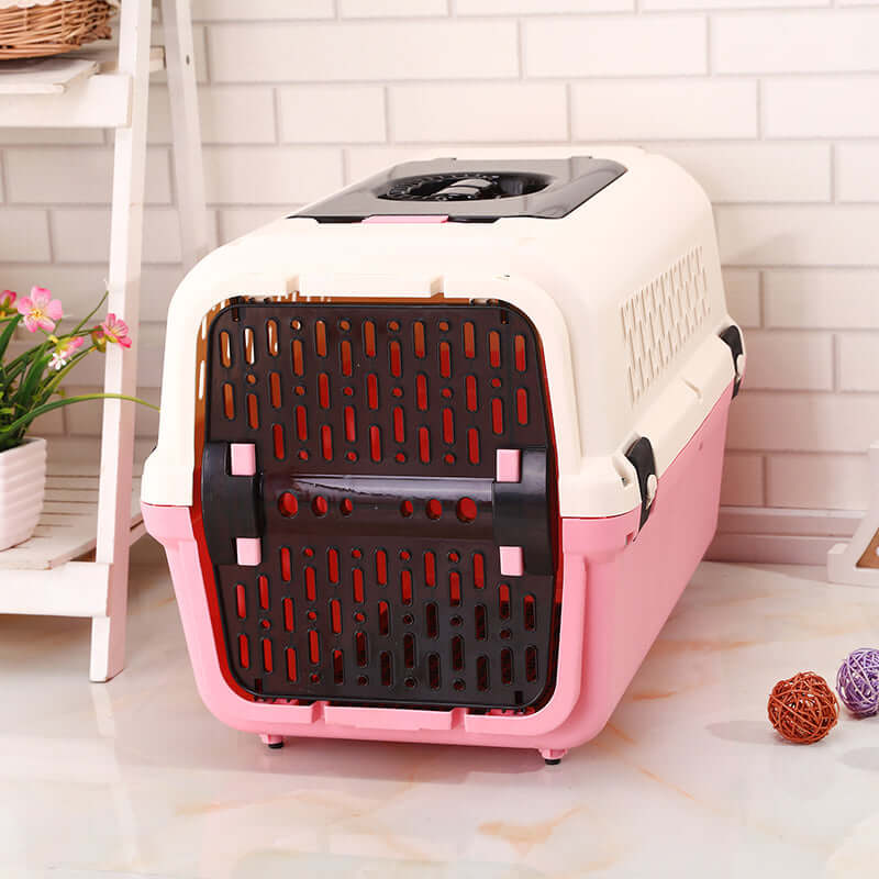 Affordable pink medium dog crate carrier with large entrance, ventilation slots, and ergonomic handle for travel.