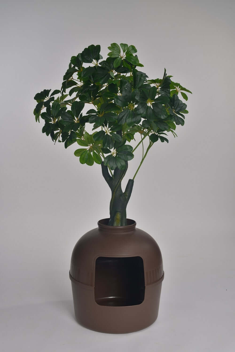 Brown multifunctional cat litter box resembling a clay pot with a decorative plant on top, ideal for quality pet care.