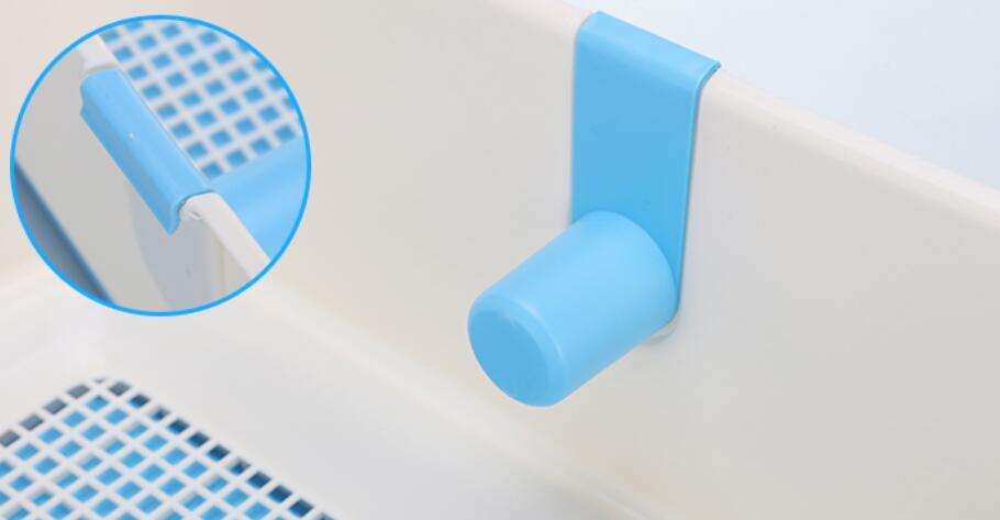 Close-up of blue attachment on a portable dog potty training tray, showcasing functional design for pet hygiene.