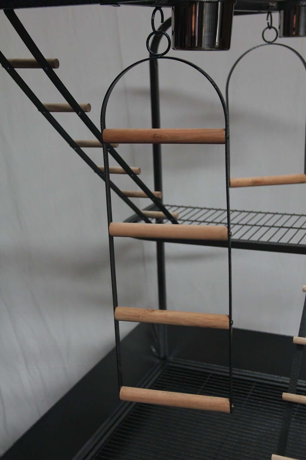 Close-up of a wooden ladder for a bird cage playpen; durable design for parrot gym activities.