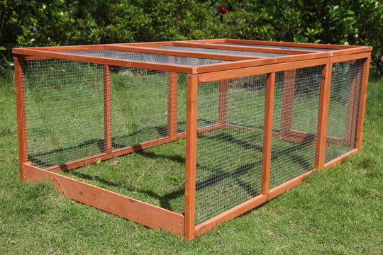 Large chicken coop run and rabbit hutch made of natural wood, perfect for small animals in a grassy yard.