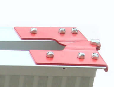 Close-up of a red and silver metal bracket with screws, showcasing a sturdy joint for secure assembly.