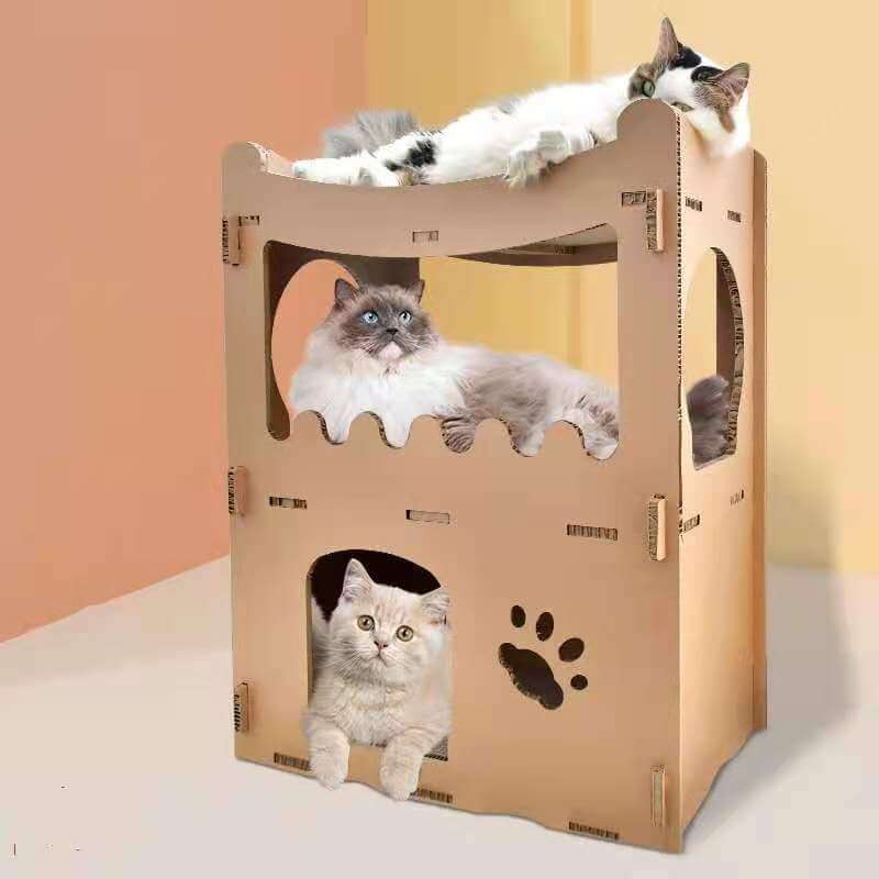 Three cats relaxing in a double storey cardboard house tower, a cozy and affordable pet furniture option.