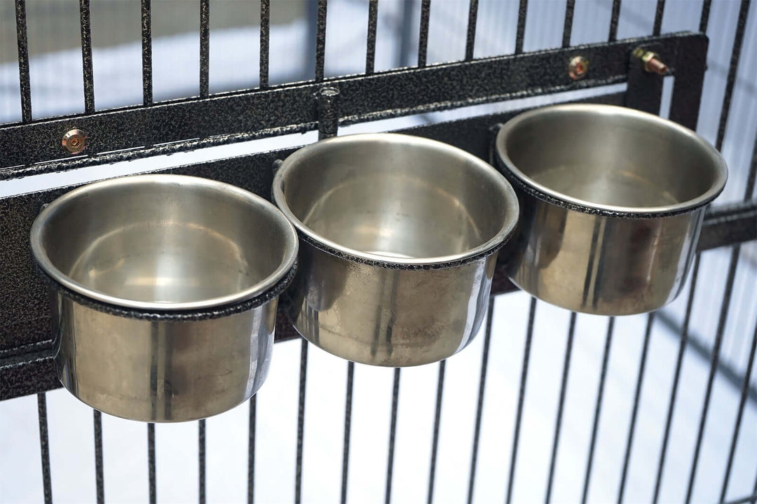 Three stainless steel food and water bowls attached to a pet cage, designed for birds, cats, and dogs.