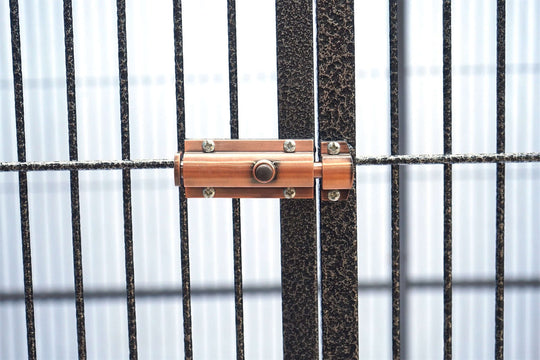 Close-up of secure lock mechanism on a bird and pet cage, showcasing durability and safety features.