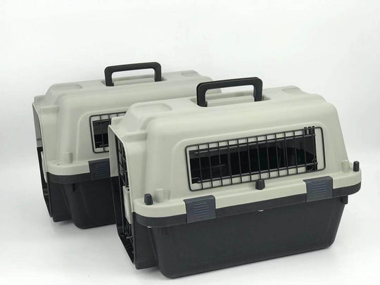 Two medium portable pet carriers with safety locks and ergonomic handles, perfect for travel with cats and small dogs.