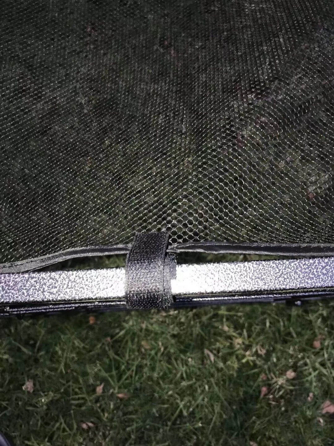 Close-up of YES4PETS heavy-duty pet playpen cover attachment showing secure fastening on grass.