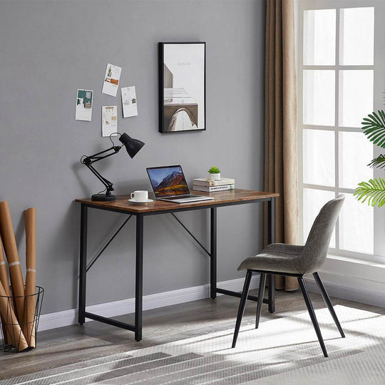 Modern home office setup featuring a sturdy computer desk and stylish chair near a window.