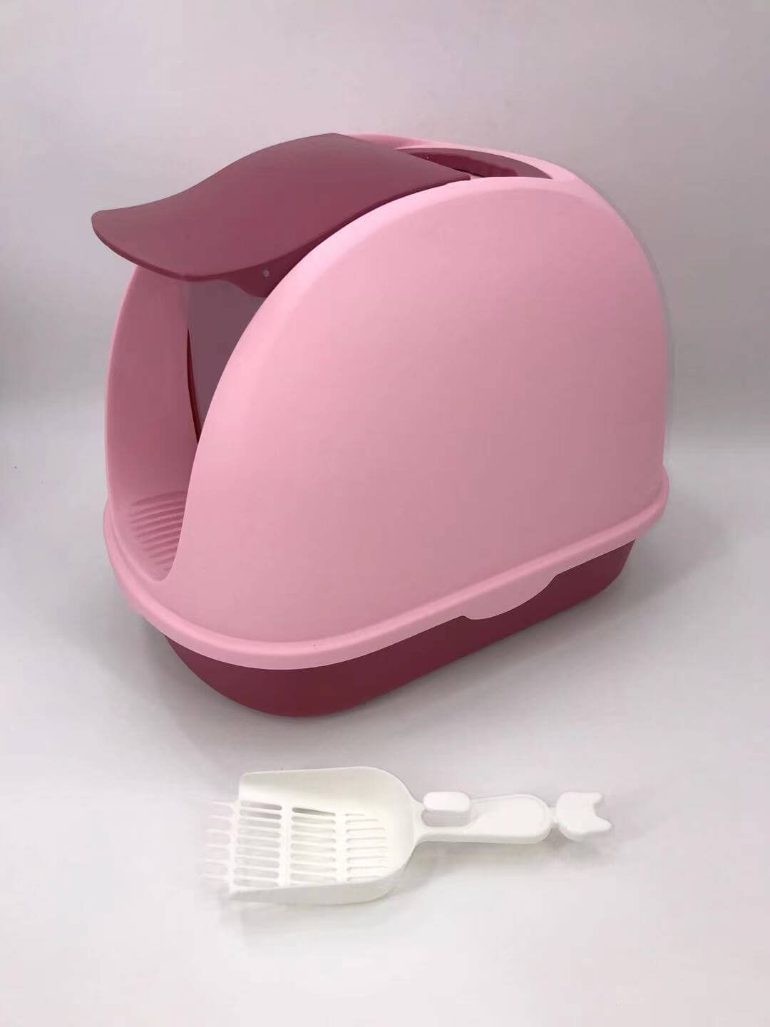 Portable hooded pink cat litter box with handle and scoop, ensuring privacy and odor control for your pet. Affordable quality design.