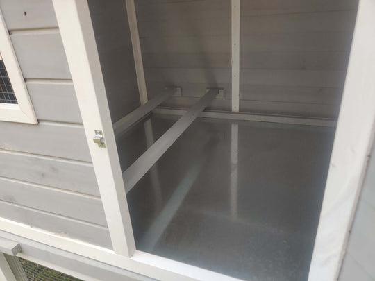 Interior view of YES4PETS chicken coop showing roosting bars and metal flooring.