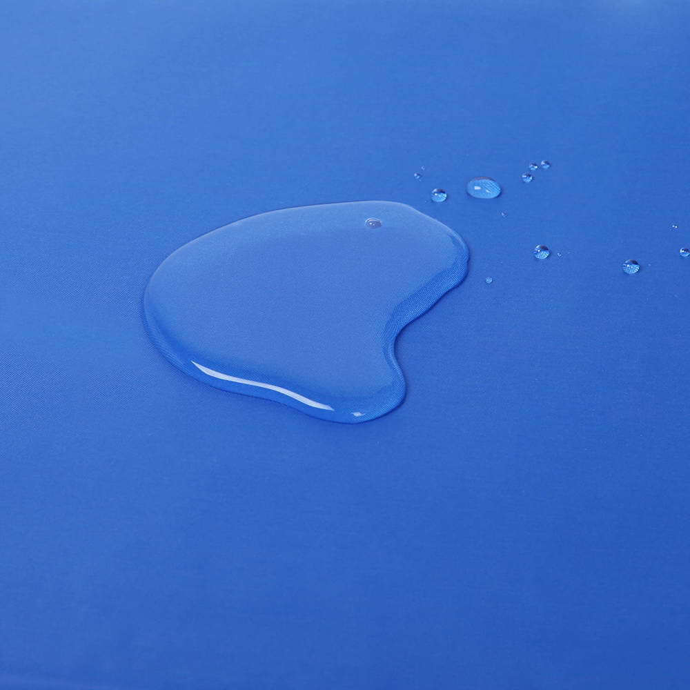 Close-up of water droplet on a blue cooling pad surface, highlighting non-toxic material quality.