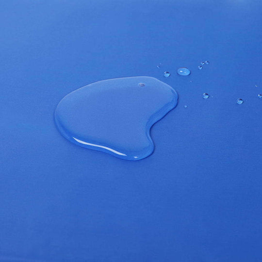 Close-up of water droplet on a blue cooling pad surface, highlighting non-toxic material quality.