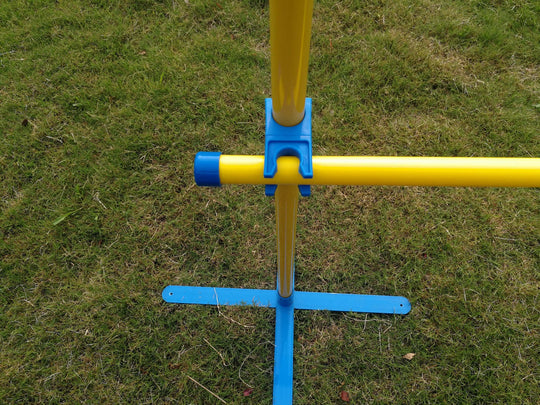 Portable dog training jump post with bright yellow and blue colors on grass, ideal for affordable DIY agility practice.