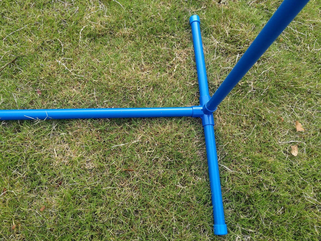 Close-up of a blue portable agility jump bar's base on grass, designed for affordable dog training.