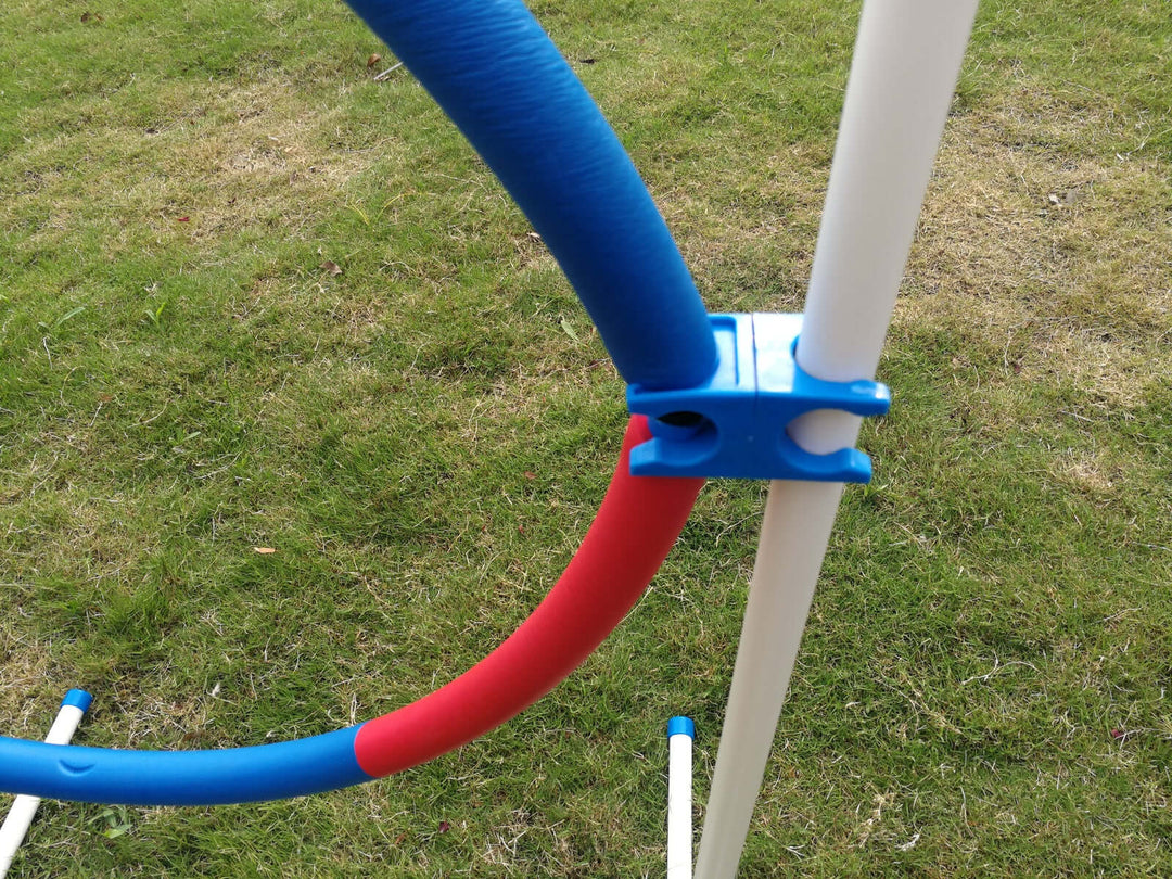 Close-up of a blue and red portable adjustable dog training jump tyre, designed for DIY agility practice.