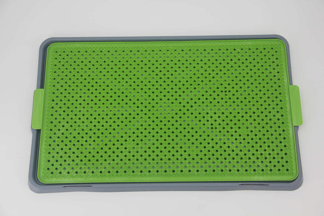 Indoor dog potty training mat in green and gray, easy to clean and ideal for pet toilet training.