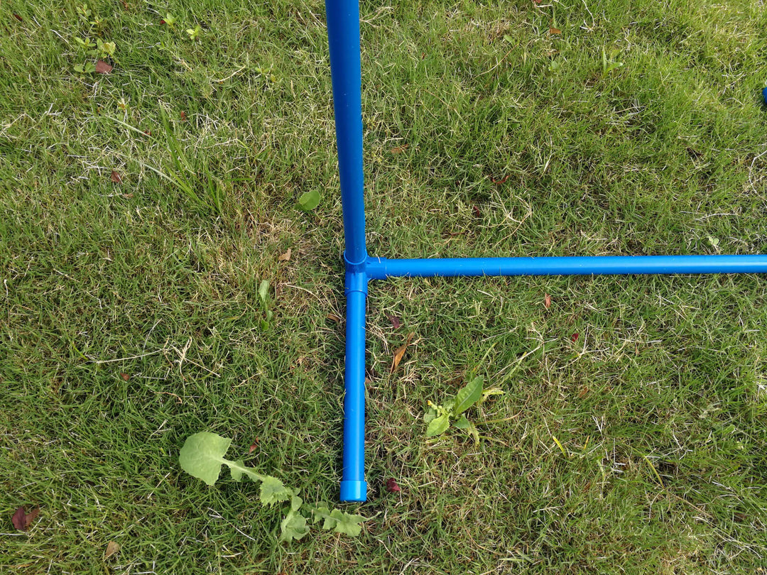 Close-up of YES4PETS portable dog training weave poles made from durable PVC, set on grass for agility practice.