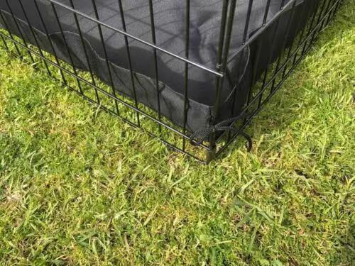 Close-up of YES4PETS 24' dog playpen base on grass, featuring a durable canvas floor for pet safety and comfort.