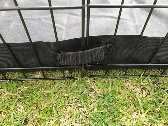 Close-up of YES4PETS playpen's square canvas floor with durable black binding on grass.