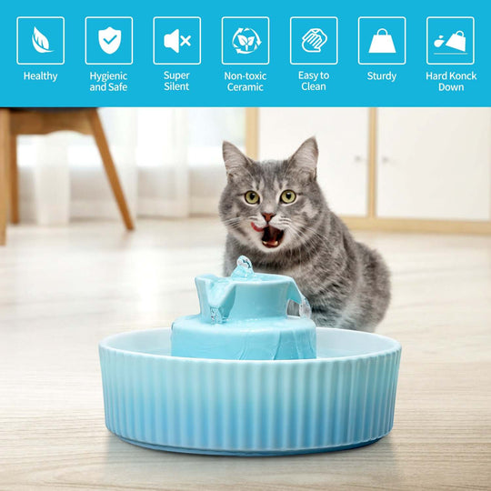 Blue ceramic automatic pet water fountain with a cat, promoting healthy hydration for pets.