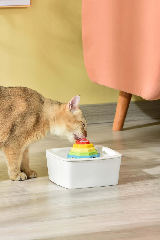 Cat enjoying water from YES4PETS ceramic automatic electric pet water fountain in a stylish setting.