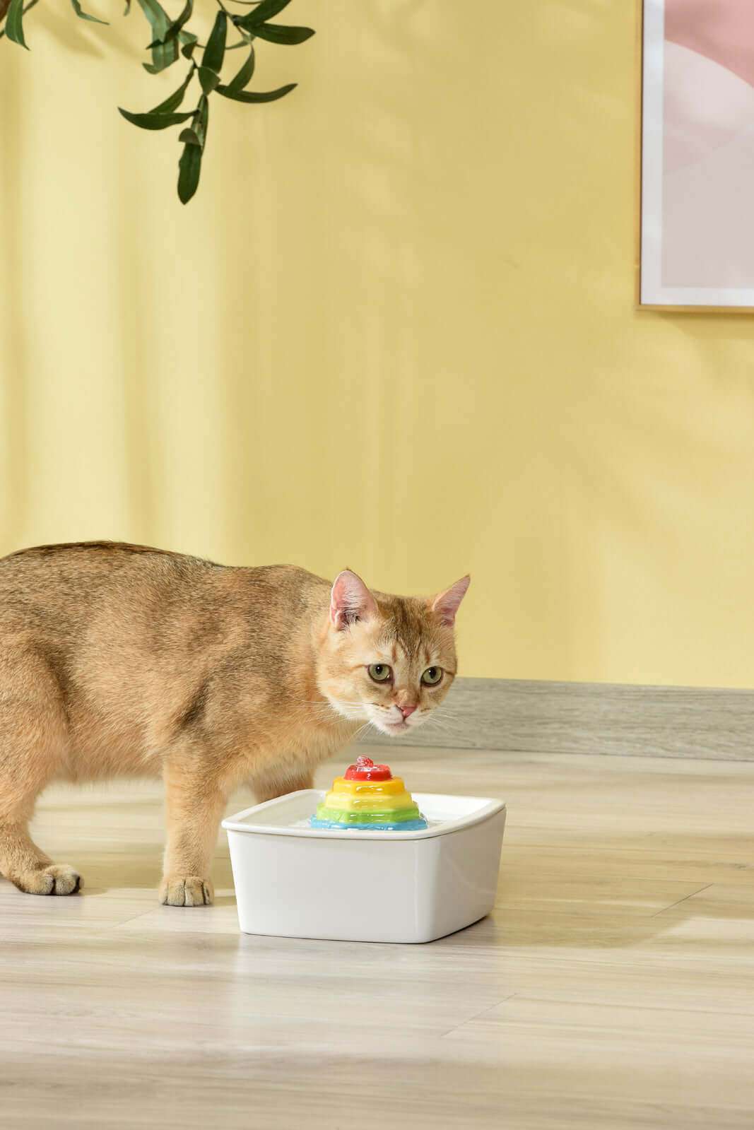 Cat drinking from YES4PETS ceramic electric water fountain in a stylish home setting.