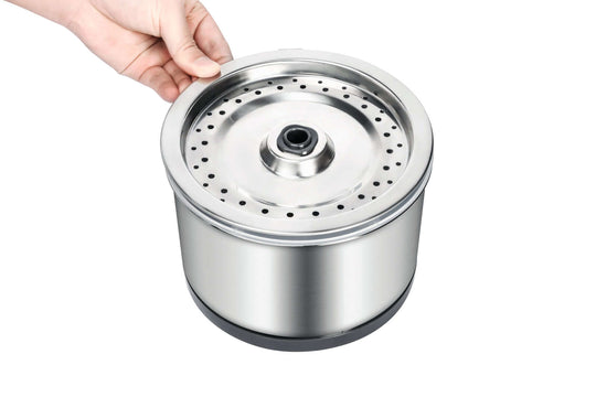 Stainless steel pet water fountain filter being held, designed for easy cleaning and durability.