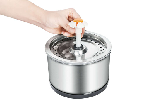 Hand holding a pet water fountain top, showcasing the stainless steel design and easy-to-use features for dogs and cats.