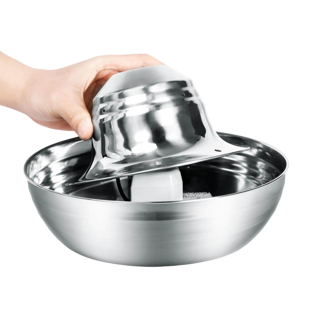 Person holding the top of a stainless steel pet water fountain, showcasing its sleek and modern design.