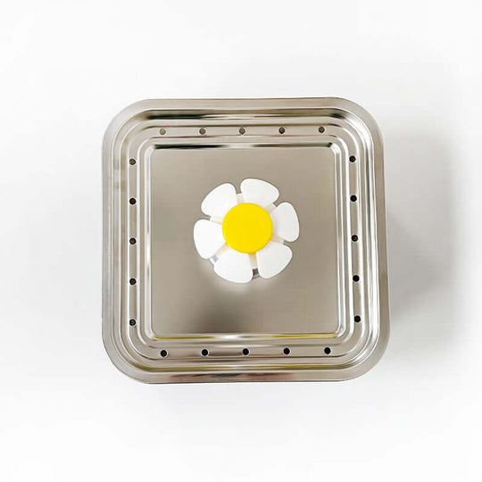 Stainless steel automatic pet water fountain top view with flower design, ideal for dogs and cats.