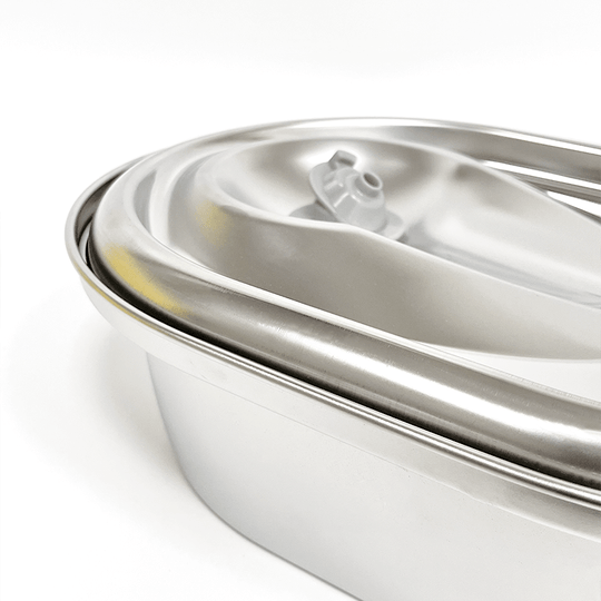 Close-up of a stainless steel automatic pet water fountain bowl dispenser for dogs and cats.