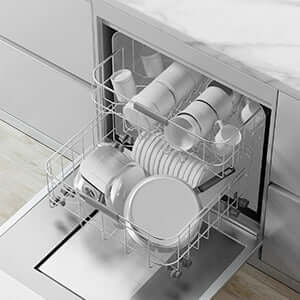 Interior view of a dishwasher loaded with clean white dishes and cups on two racks.