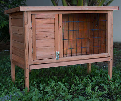 Affordable single wooden pet hutch for rabbits and guinea pigs with slide-out tray and waterproof treatment.