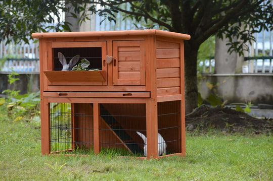 Double storey wooden rabbit hutch with access doors, suitable for small pets like rabbits and guinea pigs.