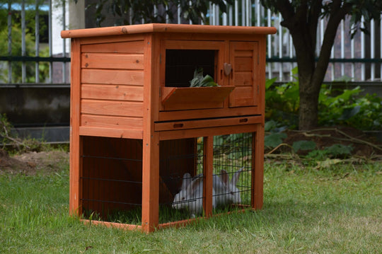 Affordable double storey rabbit hutch with pull-out tray, perfect for guinea pigs and ferrets, in a natural wood finish.