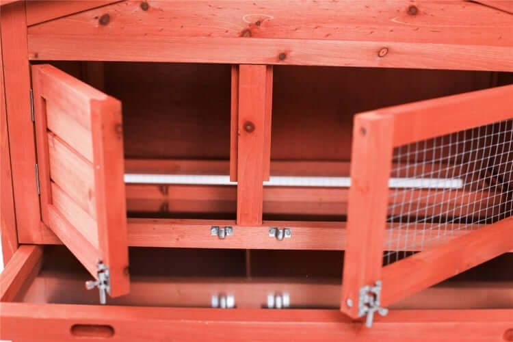 Interior view of a wooden rabbit hutch with double doors and wire mesh for ventilation, designed for affordability and quality.