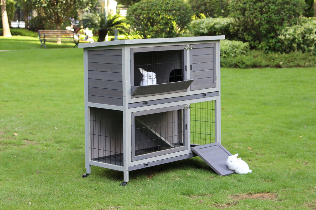 YES4PETS 110cm XL Double Storey Rabbit Hutch in garden with rabbits, featuring wheels and pull-out tray for easy access.