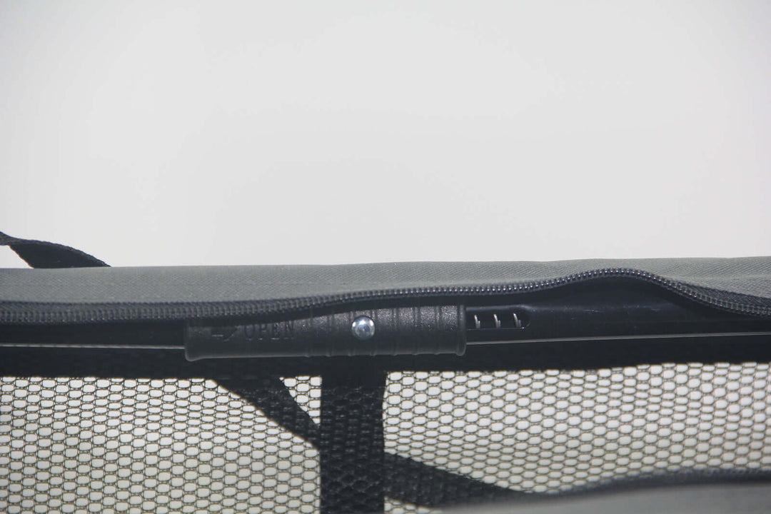 Close-up of the zipper and mesh panel of a grey portable foldable pet crate, showcasing quality and secure design.