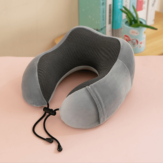 U-shaped gray memory foam travel pillow designed for neck support and comfort, ideal for travel and desk use.