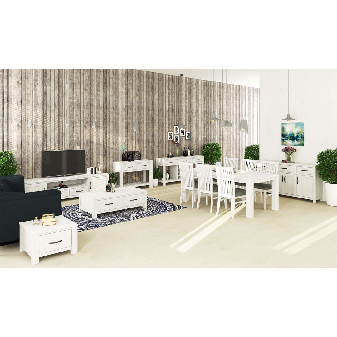 modern coastal living room with white furniture, dining table, buffet, and decorative plants in a stylish setting