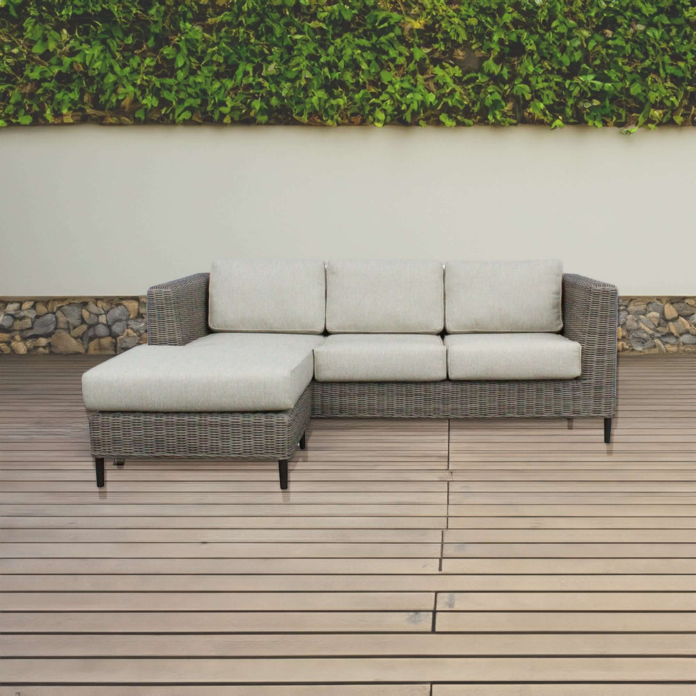 Affordable light grey rattan 3-seater outdoor sofa with reversible chaise lounge on wooden deck. Quality DIY luxury furniture.