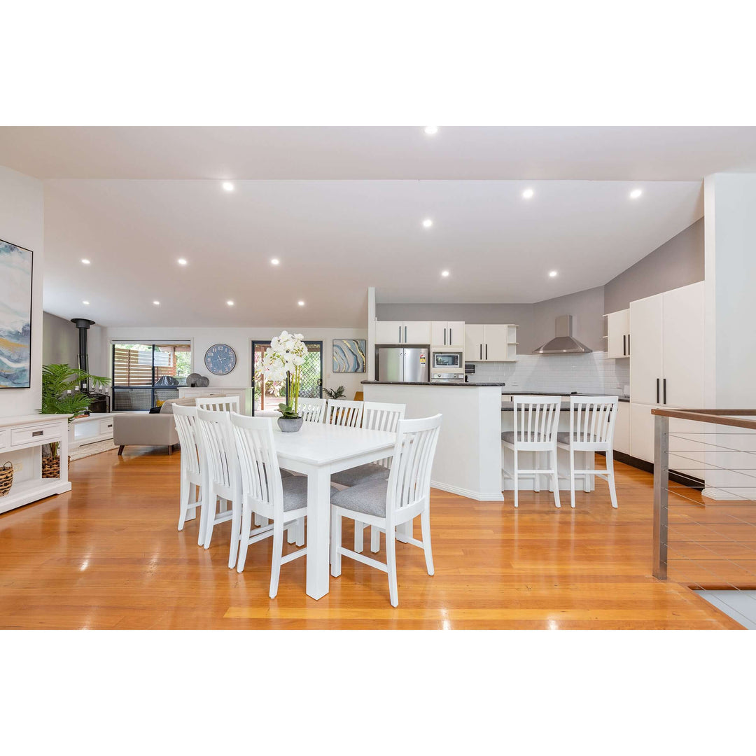 White Laelia Dining Table 220cm Solid Acacia Timber Wood in a Coastal Style Kitchen-Dining Area with Chairs and Modern Decor