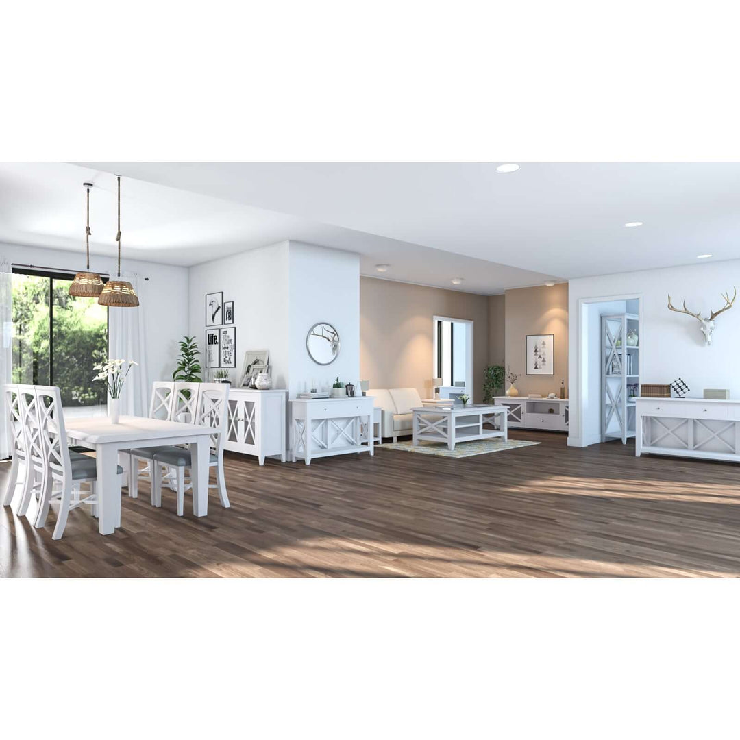 Spacious modern dining room with white Hampton style furniture, including a Daisy Dining Table, solid Acacia wood chairs, and a bright interior.