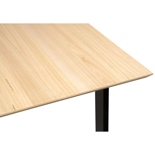 Aconite dining table made of solid messmate timber with veneer, showing wood grain and sturdy design.