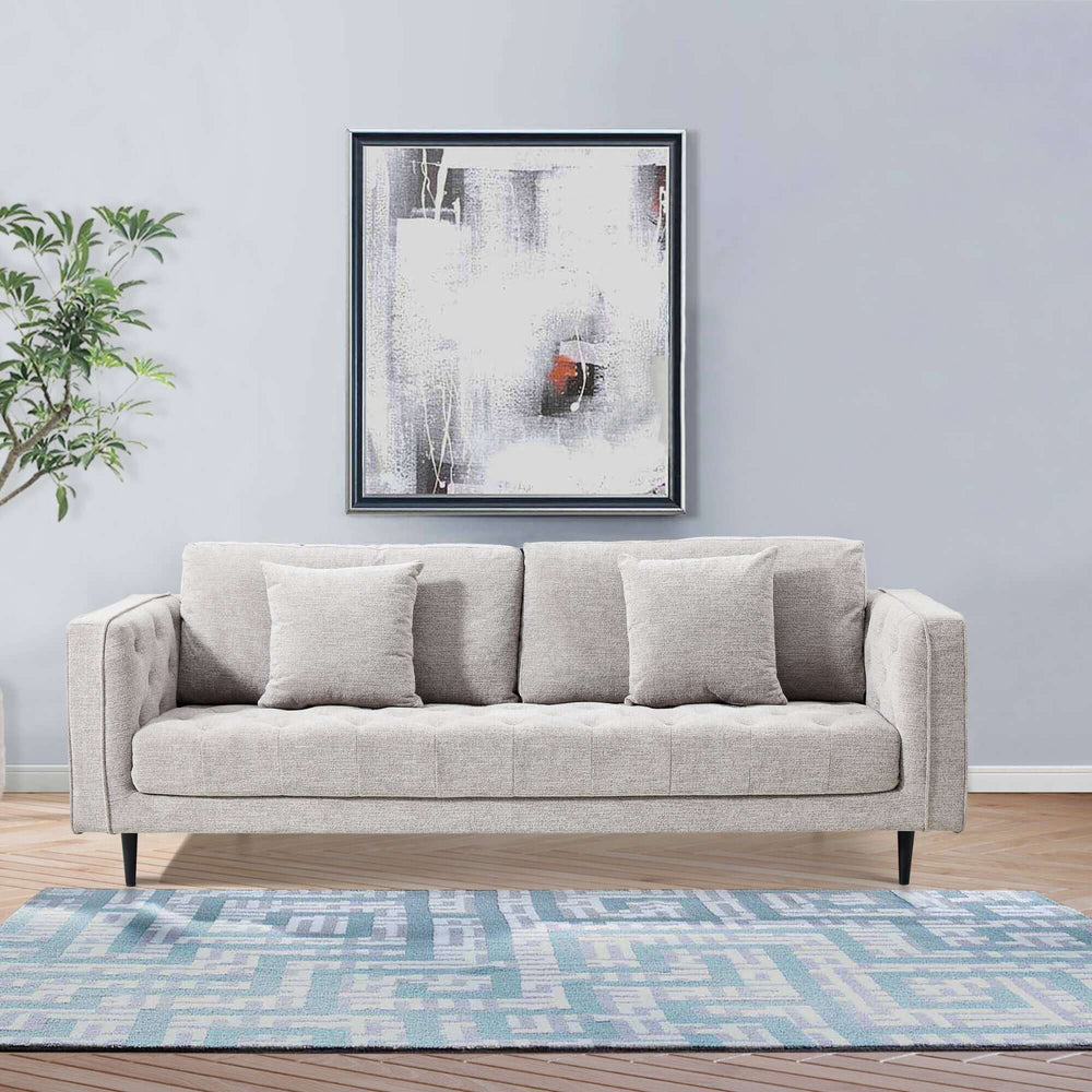 Affordable quartz 3-seater sofa with plush cushions, modern design in stylish lounge setting with abstract art.