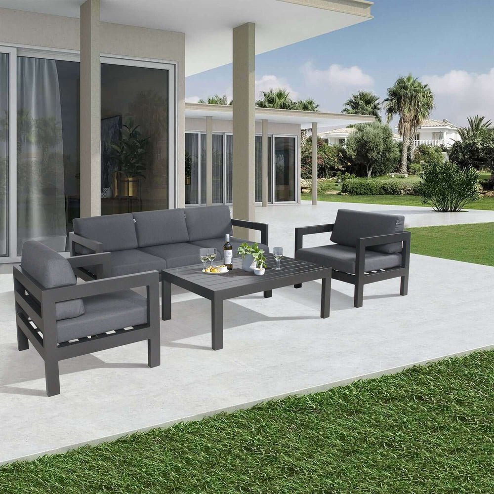 Outie 3-seater outdoor sofa lounge with aluminium frame and charcoal cushions in a contemporary patio setting.