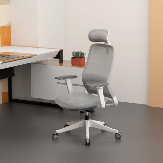 Ergonomic grey office chair with molded foam seat and adjustable features in modern workspace setting.