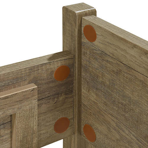 Close-up of natural wood-like MDF structure of double size oak color bed from 5 pieces bedroom suite.